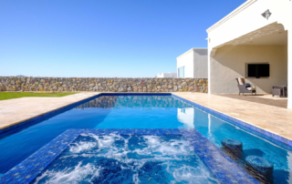 Finest Finish Sparkle Quartz Laguna pool with water feature and seating