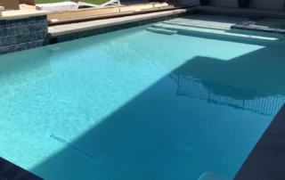 Finest Finish Sparkle Quartz White Pool ledge and step with blue tile detail 2