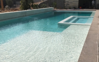 Finest Finish Sparkle Quartz White Pool with spa with ledge and steps in foreground