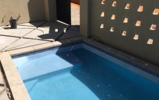 Finest Finish Sparkle Quartz Lakeside spa and pool with ledge and decorative wall