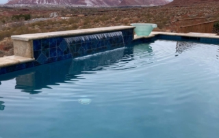 Sparkle Quartz Lakeside pool with blue tile trim, steps and water feature