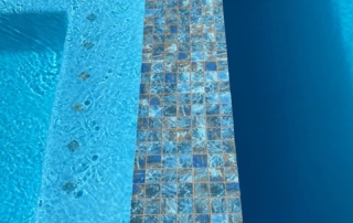 Sparkle Quartz Lakeside pool with tile detail spa seating and baja ledge