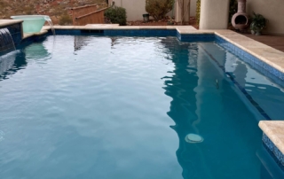 Sparkle Quartz Lakeside spa and pool with blue tile trim