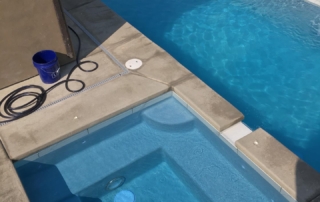Sparkle Quartz Lakeside spa and pool with marble wall and water feature