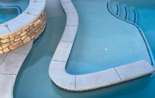 Sparkle Quartz White pool and spa with baja ledge, steps with teal blue black