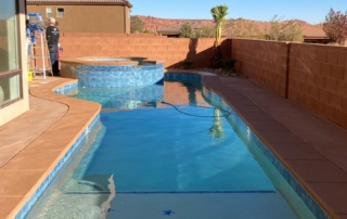 Sparkle Quartz tropical pool and spa with water feature and blue tile and terracotta decking