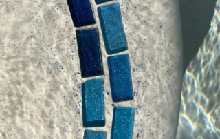 Sparkle Quartz tropical pool step with blue tile decorative trim