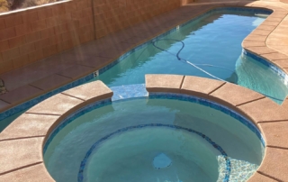Sparkle Quartz tropical spa and pool with water feature and terracotta coping