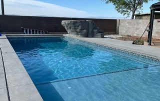 Finest Finish Sparkle Quartz Pacific pool with spa in backgrounFinest Finish Sparkle Quartz Pacific pool with shelf