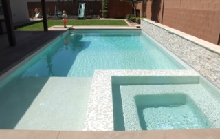 Finest Finish Sparkle Quartz Kool pool with white stone finish wall and spa with small white tile detail