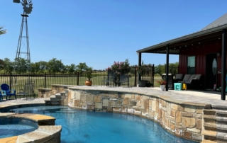 Finest Finish Sparkle Quartz Laguna rounded edge spa and pool with with stonework wall and windmill