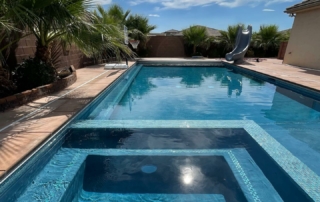 Finest Finish Sparkle Quartz Laguna spa and pool with baja shelf, tile detail, water slide and basket ball net