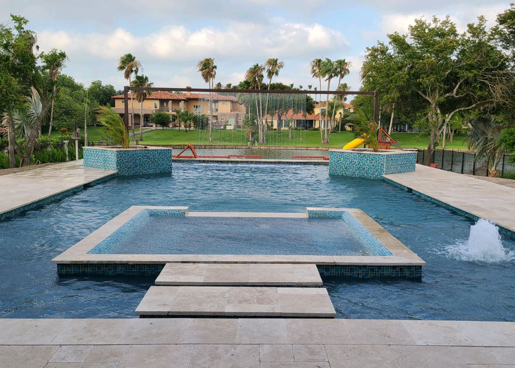 Blue Star Tropical Breeze pool with water curtain, spa and spa steps